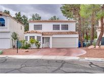 Charming two-story home featuring a neutral stucco facade, red tile roof, and meticulously maintained front yard with ample parking at 3491 Bankside Dr, Las Vegas, NV 89129