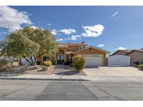 Charming two-story home featuring a spacious driveway, well-manicured landscaping, and an attached two-car garage at 645 Paloma Dr, Boulder City, NV 89005