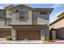 Two-story home featuring a two-car garage, and neutral stucco exterior at 73 Lomita Heights Dr, Las Vegas, NV 89138