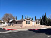 Charming single-story home featuring mature landscaping, a neutral color palette, and a well-maintained yard at 798 Shirley Ln, Boulder City, NV 89005