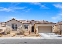 Charming single-story home featuring stucco siding, a tile roof, and a two-car garage at 8140 Redbud Vine St, North Las Vegas, NV 89085