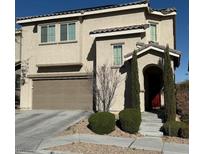 Two-story home featuring a two-car garage and a welcoming front entrance with desert landscaping at 9138 Sea Mink Ave, Las Vegas, NV 89149