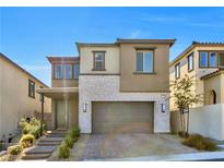 Beautiful two-story home with a stone facade and attached two-car garage at 12125 Arrebol Ave, Las Vegas, NV 89138