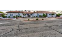 Charming home featuring stucco exterior, tile roof, and low-maintenance desert landscaping at 1780 Westwind Rd, Las Vegas, NV 89146