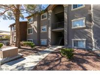 Exterior shot of a building with manicured landscaping and walkways on a sunny day at 2750 S Durango Dr # 2012, Las Vegas, NV 89117