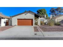 Charming single-story home featuring a red garage door and low-maintenance landscaping at 4768 W Montara Cir, Las Vegas, NV 89121