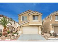 Charming two-story home with tan stucco, a two-car garage and desert landscaping at 4787 Essen Ct, Las Vegas, NV 89147