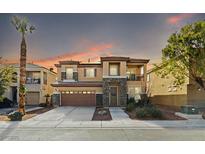 Inviting two-story home featuring a stone facade, a well-manicured front yard, and a spacious two car garage at 7017 Pink Flamingos Pl, North Las Vegas, NV 89084