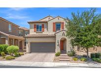 Two-story home showcasing neutral stucco, decorative shutters, a two-car garage and a well-maintained, landscaped front yard at 7171 Willow Moss Ct, Las Vegas, NV 89148