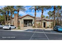 Attractive clubhouse with desert landscaping and ample parking on a sunny day at 8000 W Badura Ave # 2021, Las Vegas, NV 89113