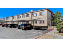 A tan condo with a covered parking area on a sunny day at 8725 W Flamingo Rd # 208, Las Vegas, NV 89147