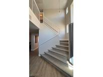 Carpeted staircase with white railing leads to upper level of the home at 9328 Jumpin Juniper Ave, Las Vegas, NV 89129