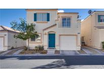 Charming two-story home featuring a delightful blue door and a cozy second-floor balcony at 9944 Swimming Hole St, Las Vegas, NV 89183