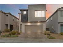 Modern two-story home featuring a two-car garage and contemporary design, with neat front yard landscaping at 10190 Natural Anchor St, Las Vegas, NV 89166