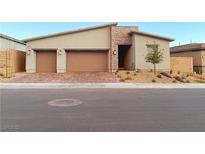 Charming home with a two-car garage, stone accents, manicured landscaping and neutral stucco siding at 116 Juliette Pointe Ln, Henderson, NV 89011