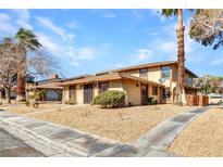 Inviting two-story home with desert landscaping and sidewalk at 1344 Lorilyn Ave # 3, Las Vegas, NV 89119