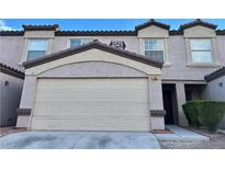 Townhouse featuring a two-car garage, warm color palette, and a well-maintained exterior at 2525 Sierra Bello Ave # 103, Las Vegas, NV 89106