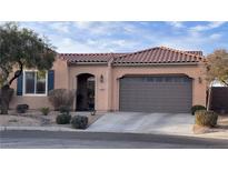 Charming single-story home features a two-car garage, arched entryway, and well-maintained landscaping at 2764 Leys Burnett Ave, Henderson, NV 89044