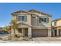 Two-story home with a neutral-colored exterior, brown shutters, a two-car garage, and desert landscaping at 4813 Stony Hill St, North Las Vegas, NV 89031