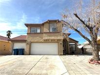 Inviting two-story home featuring a well-maintained yard, attached two-car garage, and attractive exterior design at 5255 Autumn Sky Rd, Las Vegas, NV 89118