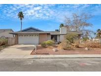 Charming single-story home featuring an attached two-car garage and mature landscaping at 700 Northstar St, Las Vegas, NV 89107