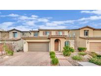 Inviting two-story home with a well-maintained front yard and a brick driveway leading to a two-car garage at 12816 Alcores St, Las Vegas, NV 89141