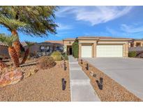 Charming single-story home featuring a three-car garage and desert landscaping at 2540 Thatcher Ave, Henderson, NV 89052