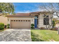 Charming single-story home featuring a well-manicured lawn and a classic two-car garage with traditional design elements at 5965 Poplar Tree St, Las Vegas, NV 89148