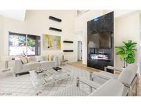 Bright living room features modern fireplace, high ceilings, and contemporary decor at 6628 Silver Penny Ave, Las Vegas, NV 89108