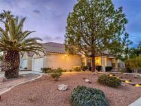 Charming single-story home with a well-maintained front yard featuring desert landscaping and a lovely palm tree at 7608 Little Valley Ave, Las Vegas, NV 89147