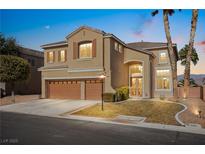 Two-story home featuring stucco, three-car garage, well-manicured yard and landscaping at 8106 Buffalo Clan Ct, Las Vegas, NV 89131