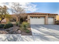 Charming single-story home features a tile roof, desert landscaping, and a three-car garage at 2329 Quartz Peak St, Las Vegas, NV 89134