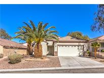 Charming single-story home featuring a two-car garage, desert landscaping, and mature palm trees in front at 2554 Corvus St, Henderson, NV 89044