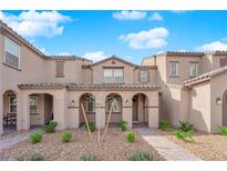 Inviting townhome exterior with desert landscaping, covered porch, and neutral color palette at 2607 Aversa St, Henderson, NV 89044