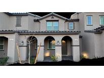 Charming two-story townhouse with arched entryway and neutral-toned exterior at 2607 Aversa St, Henderson, NV 89044