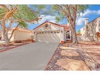 Charming home featuring a two-car garage, red tile roof, and desert landscaping at 3916 Rhine Way, Las Vegas, NV 89108