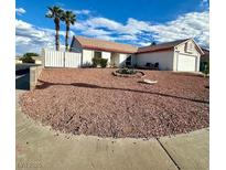 Charming single-story home featuring a low maintenance xeriscaped front yard and white fencing at 470 Como Ct, Henderson, NV 89015