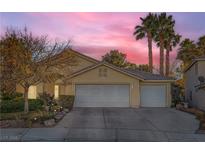 Charming single Gathering home featuring a three-car garage, well-maintained landscaping, and mature palm trees at 5022 Arizo Ct, North Las Vegas, NV 89031