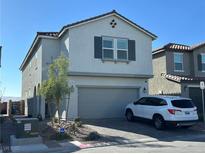 Charming two-story home featuring a symmetrical facade, a two car garage, and manicured landscaping at 5161 Birchland Manor Ave, Las Vegas, NV 89139