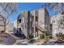 Condo exterior featuring multiple levels with stairs and landscaped surroundings at 5250 S Rainbow Blvd # 1121, Las Vegas, NV 89118