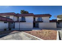 Two-story townhome featuring balconies, brick facade, and manicured front yard at 701 Bourbon St # G3, Pahrump, NV 89048