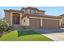 Attractive home featuring a double-door entry, three-car garage, and red tile roof at 767 Durgos Dr, Henderson, NV 89012