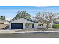 Charming single-story home featuring a well-manicured front yard and a two-car garage at 865 Armada Pl, Boulder City, NV 89005