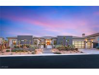 Beautiful single-story home featuring modern design, desert landscaping, and a three-car garage at 9729 Glistening Brook Ct, Las Vegas, NV 89149