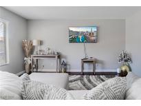 Cozy living room with a plush area rug, modern decor, and a wall-mounted television at 1888 Apricot Ct, Henderson, NV 89014