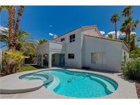 Beautiful backyard pool with mature palm trees and sunny skies at 2010 Spruce Brook Dr, Henderson, NV 89074