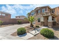 Inviting two-story home showcasing stone accents, well-manicured landscaping, and a private driveway at 2765 Rochester Run Ave, Henderson, NV 89052