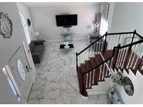 Bright living room showcasing a cozy gray sofa, marble floors, and elegant decor from an elevated view at 2913 Domino Way, Las Vegas, NV 89117