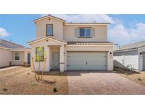 Charming two-story home with a tan exterior, paved driveway, and well-manicured landscaping at 6737 Violet Cascade Ave, Las Vegas, NV 89156