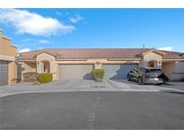 Charming townhome featuring desert landscaping, attached garages and a lovely tile roof at 9304 Cranesbill Ct, Las Vegas, NV 89149